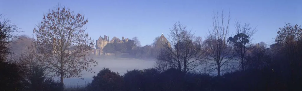 A view of Battle Abbey with mist rising in the foreground